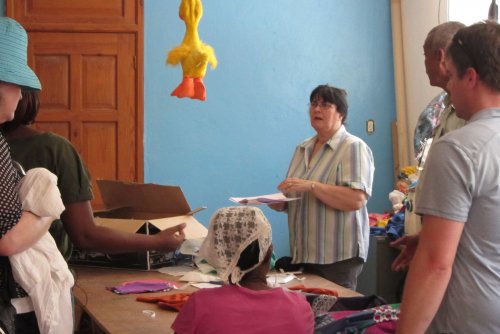  Diane explains to the group who traveled with her to Haiti about the vocational garment making program and training 